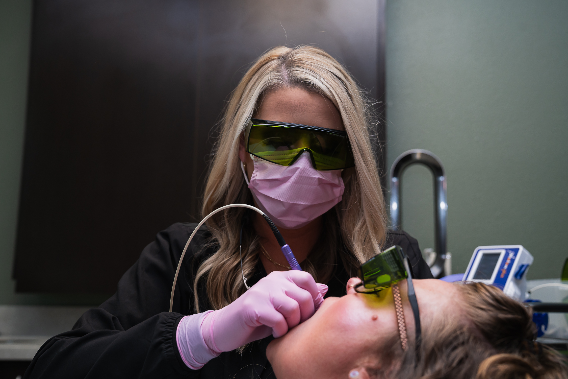 dentist checking a patient's mouth in Rogers, AR